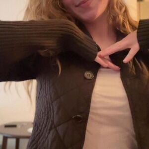 Brown quilted jacket with ribbed cuffs and collar, featuring a button-up design